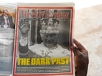 A Kenyan reads the Daily Nation newspaper with a portrait of Britain's King Charles III and the headline 'The Dark Past' in Nairobi. A Kenyan reads the Daily Nation newspaper with a portrait of Britain's King Charles III and the headline 'The Dark Past' in Nairobi.