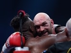 Tyson Fury, of England, the WBC and lineal heavyweight champion, facing, hugs former UFC heavyweight champion Francis Ngannou, of Cameroon, at their boxing match