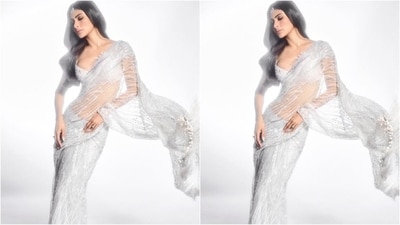 Mouni's dazzling saree is from the shelves of clothing brand Dilnaz and is made from a net fabric that is embellished all over with intricate esquin embroidery. She paired it with a silver shimmering bralette blouse featuring a plunging neckline. (Instagram/@imouniroy) Mouni's dazzling saree is from the shelves of clothing brand Dilnaz and is made from a net fabric that is embellished all over with intricate esquin embroidery. She paired it with a silver shimmering bralette blouse featuring a plunging neckline. (Instagram/@imouniroy)