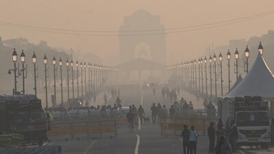 Commuters out on a smoggy morning amid rising air pollution at Kartavya Path in New Delhi on Saturday. (Arvind Yadav/ Hindustan Times)