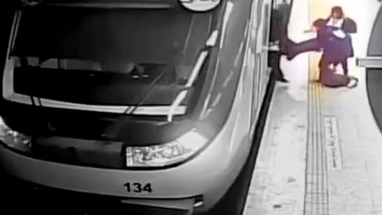 In this image from surveillance video aired by Iranian state television, women pull 16-year-old Armita Geravand from a train car on the Tehran Metro on October 1. (AP)