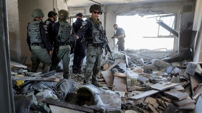 Israel-Hamas War: Emergency responders inspect a building damaged by a rocket that was launched from the Gaza Strip. (Reuters)