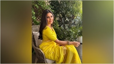 Katrina wore the drape with a matching yellow silk blouse featuring a plunging V neckline, half-length sleeves, gold lining on the cuffs, cropped hem length, and a fitted silhouette. She accessorised the traditional look with ornate gold kadhas and statement jhumkas adorned in pearls. (Instagram) Katrina wore the drape with a matching yellow silk blouse featuring a plunging V neckline, half-length sleeves, gold lining on the cuffs, cropped hem length, and a fitted silhouette. She accessorised the traditional look with ornate gold kadhas and statement jhumkas adorned in pearls. (Instagram)
