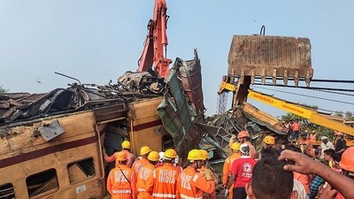 NDRF personnel during a rescue and restoration work after multiple coaches of two passenger trains derailed following a collision in Vizianagaram district on October 30. (PTI)