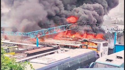 Smoke and flames billow out after buses parked at a private garage caught fire, at Veerabhadra Nagar in Bengaluru on Monday. (ANI)