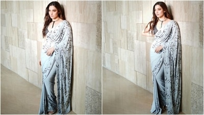 Tamannaah styled the six yards with a sleeveless black blouse decked in heavy black bead embellishments. It featured a plunging neckline, cropped hem, and a figure-hugging fitting. She accessorised the outfit with a statement metal choker necklace, rings, ear studs, and stilettos. (Instagram) Tamannaah styled the six yards with a sleeveless black blouse decked in heavy black bead embellishments. It featured a plunging neckline, cropped hem, and a figure-hugging fitting. She accessorised the outfit with a statement metal choker necklace, rings, ear studs, and stilettos. (Instagram)