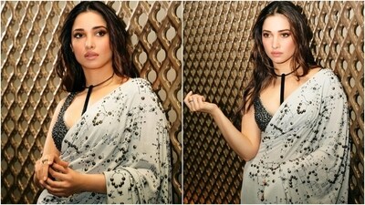 Meanwhile, Tamannaah's photoshoot shows her dressed in a chiffon number from the shelves of Qbik. She shared the pictures with the caption, "Not sorry for another saree." The ivory six yards feature black beaded embellishments and a quirky pattern in the same shade. The star wore it traditionally, with the pallu falling from the shoulder in a floor-sweeping length. (Instagram) Meanwhile, Tamannaah's photoshoot shows her dressed in a chiffon number from the shelves of Qbik. She shared the pictures with the caption, "Not sorry for another saree." The ivory six yards feature black beaded embellishments and a quirky pattern in the same shade. The star wore it traditionally, with the pallu falling from the shoulder in a floor-sweeping length. (Instagram)
