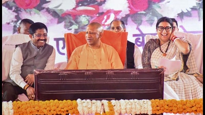 UP CM Yogi Adityanath with Union Minister and Amethi MP Smriti Irani and UP minister Nand Gopal Gupta 'Nandi' during inauguration of Coca Cola bottling plant in Amethi on October 30. (PTI) UP CM Yogi Adityanath with Union Minister and Amethi MP Smriti Irani and UP minister Nand Gopal Gupta 'Nandi' during inauguration of Coca Cola bottling plant in Amethi on October 30. (PTI)
