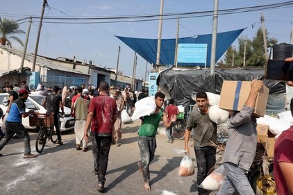 Palestinians storm a UN-run aid supply center, that distributes food to displaced families following Israel's call for more than one million residents in northern Gaza to move south for their safety, in Deir al-Balah on October 28, 2023. (AFP)