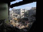 Palestinians conduct search and rescue works at the site of an Israeli strike on a house in Rafah in the southern Gaza Strip