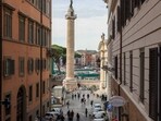 Pedestrians pass Traian's Column in Piazza Venezia in downtown Rome, Italy. Pedestrians pass Traian's Column in Piazza Venezia in downtown Rome, Italy.