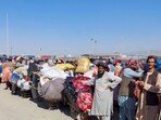 Afghan citizens wait with their belongings to cross into Afghanistan, after Pakistan gives the last warning to undocumented immigrants to leave, at the Friendship Gate of Chaman Border Crossing.