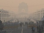 Commuters out on a smoggy morning amid rising air pollution at Kartavya Path in New Delhi 