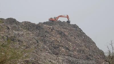 A JCB machine tackles the waste mountain at the Bandhwari landfill site on the Gurugram-Faridabad Road on Monday. (Parveen Kumar/HT Photo) A JCB machine tackles the waste mountain at the Bandhwari landfill site on the Gurugram-Faridabad Road on Monday. (Parveen Kumar/HT Photo)