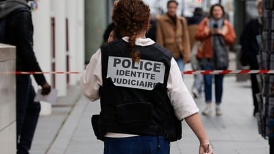 A French police officer wears a jacket, identifying herself as "Police identite judiciaire"), while walking from a metro station. (AFP) A French police officer wears a jacket, identifying herself as "Police identite judiciaire"), while walking from a metro station. (AFP)