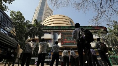 People look at a screen displaying the Sensex results on the facade of the Bombay Stock Exchange (BSE) building in Mumbai. (REUTERS)