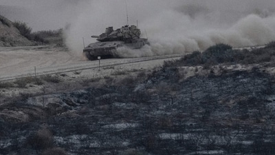 This picture taken from a position near Sderot along the border with the Gaza Strip on October 31, 2023 shows an Israeli tank driving near the border. (AFP) This picture taken from a position near Sderot along the border with the Gaza Strip on October 31, 2023 shows an Israeli tank driving near the border. (AFP)