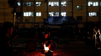 Israel-Hamas War: Palestinians cook on a wood fire during a power cut, amid the ongoing conflict between Israel and Hamas, in Khan Younis. (Reuters)