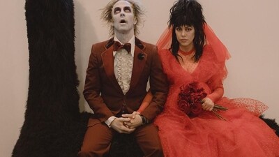 Travis Barker and Kourtney Kardashian dressed up as Beetlejuice and Lydia Deetz from the 90s TV show Beetlejuice for Halloween. Kourtney also held a bunch of red roses to go with her look. Travis Barker and Kourtney Kardashian dressed up as Beetlejuice and Lydia Deetz from the 90s TV show Beetlejuice for Halloween. Kourtney also held a bunch of red roses to go with her look. 