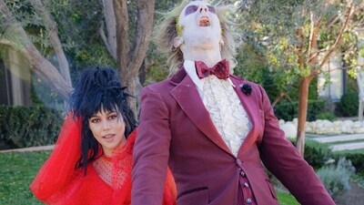 Kourtney Kardashian served another Halloween look in a red sheer dress and a rough hairdo. Husband Travis Barker decked up in a purple suit, powdered face and a wig as they played Lydia Deetz and Beetlejuice. Kourtney Kardashian served another Halloween look in a red sheer dress and a rough hairdo. Husband Travis Barker decked up in a purple suit, powdered face and a wig as they played Lydia Deetz and Beetlejuice.