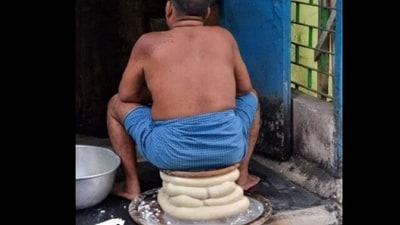Picture of the man sitting on a pile of paneer. (X/@zhr_jafri )