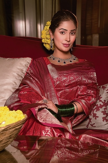 .Sahai’s lehenga by Asha Gautam is inspired by the holy city of Vrindavan. It depicts the life and time of Lord Krishna, where the gopis are frolicking, cattle are grazing and Nature is blooming in all its glory. It features resham, zardozi and moti work. Sahai’s outfit is styled with two dupattas—a Banarasi organza and a floral tulle one with hand embroidery on the border. .Sahai’s lehenga by Asha Gautam is inspired by the holy city of Vrindavan. It depicts the life and time of Lord Krishna, where the gopis are frolicking, cattle are grazing and Nature is blooming in all its glory. It features resham, zardozi and moti work. Sahai’s outfit is styled with two dupattas—a Banarasi organza and a floral tulle one with hand embroidery on the border.