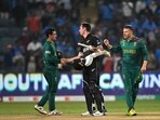 New Zealand's Matt Henry (C) greets South Africa's Quinton de Kock (L) as David Miller watches at the end of the 2023 ICC Men's Cricket World Cup one-day international (ODI) match New Zealand's Matt Henry (C) greets South Africa's Quinton de Kock (L) as David Miller watches at the end of the 2023 ICC Men's Cricket World Cup one-day international (ODI) match