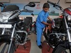 A worker cleans a bike inside a Hero MotoCorp showroom in Mumbai.