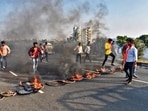Members of Maratha Kranti Morcha burn tyres and other inflamable items on Pune-Solapur Highway, on Tuesday. (PTI) Members of Maratha Kranti Morcha burn tyres and other inflamable items on Pune-Solapur Highway, on Tuesday. (PTI)