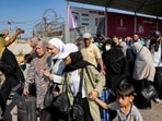 People walk through a gate to enter the Rafah border crossing to Egypt in the southern Gaza Strip People walk through a gate to enter the Rafah border crossing to Egypt in the southern Gaza Strip