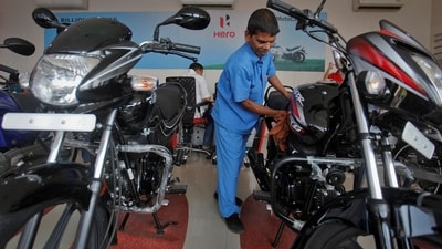 A worker cleans a bike inside a Hero MotoCorp showroom in Mumbai. (REUTERS)