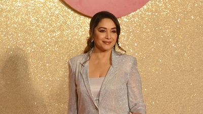 Madhuri Dixit Nene radiated confidence and elegance as she made her entrance at the event wearing a silver shimmery coat and pants, projecting a strong and sophisticated aura. (AFP) Madhuri Dixit Nene radiated confidence and elegance as she made her entrance at the event wearing a silver shimmery coat and pants, projecting a strong and sophisticated aura. (AFP)
