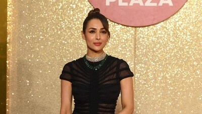 Malaika Arora effortlessly captured everyone's attention with her breathtaking appearance at the event. She wore an all-black high-neck dress that left a lasting impression. (AFP) Malaika Arora effortlessly captured everyone's attention with her breathtaking appearance at the event. She wore an all-black high-neck dress that left a lasting impression. (AFP)