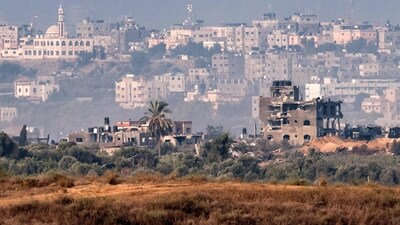 This picture from a position along the border with the Gaza Strip in southern Israel shows buildings destroyed by Israeli bombardment on the backdrop of the Gaza skyline (AFP) This picture from a position along the border with the Gaza Strip in southern Israel shows buildings destroyed by Israeli bombardment on the backdrop of the Gaza skyline (AFP)