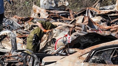 Israeli army soldiers inspect some of the hundreds of burnt vehicles that were destroyed in the October 7 attack. (AFP) Israeli army soldiers inspect some of the hundreds of burnt vehicles that were destroyed in the October 7 attack. (AFP)