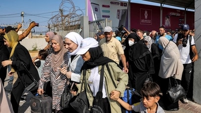 People walk through a gate to enter the Rafah border crossing to Egypt in the southern Gaza Strip (AFP) People walk through a gate to enter the Rafah border crossing to Egypt in the southern Gaza Strip (AFP)