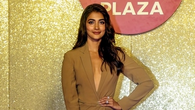 Pooja Hegde made her entrance at the event wearing a brown dress with a thigh-high slit and a plunging neckline. She opted for a bold makeup look and left her hair down and flowing. (PTI) Pooja Hegde made her entrance at the event wearing a brown dress with a thigh-high slit and a plunging neckline. She opted for a bold makeup look and left her hair down and flowing. (PTI)