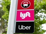 FILE PHOTO: A sign marks a rendezvous location for Lyft and Uber users at San Diego State University in San Diego, California, U.S., May 13, 2020.  