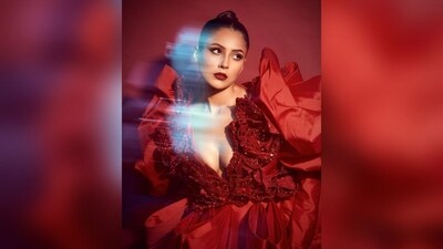 Her glamorous gown featured a plunging v-neckline, puffed shoulders, a red rose pattern with shimmer at the top and multiple ruffles at the bottom, adding the oompoh factor to her show-stopping look. (Instagram/@shehnaazgill) Her glamorous gown featured a plunging v-neckline, puffed shoulders, a red rose pattern with shimmer at the top and multiple ruffles at the bottom, adding the oompoh factor to her show-stopping look. (Instagram/@shehnaazgill)
