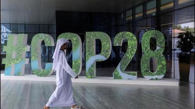 A person walks past a "#COP28" sign during The Changemaker Majlis, a one-day CEO-level thought leadership workshop focused on climate action, in Abu Dhabi, UAE, ON October 1 (REUTERS) A person walks past a "#COP28" sign during The Changemaker Majlis, a one-day CEO-level thought leadership workshop focused on climate action, in Abu Dhabi, UAE, ON October 1 (REUTERS)