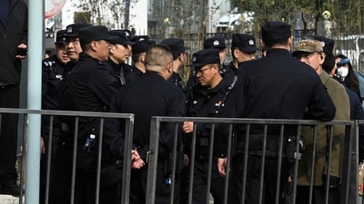 Security guards are seen at an entrance to the Babaoshan Revolutionary Cemetery in Beijing. (AFP)