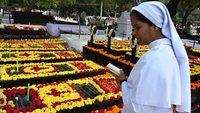 A Catholic nun offers prayers next to the graves of deceased sisters at a cemetery during All Souls Day in Hyderabad. (AFP)