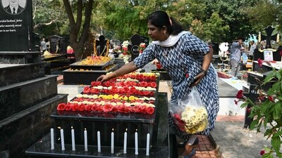 A Catholic Christian places roses over the grave of a family member at a cemetery during All Souls' Day in Hyderabad. (AFP)