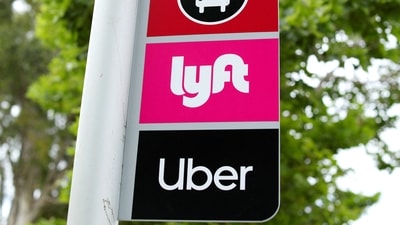 FILE PHOTO: A sign marks a rendezvous location for Lyft and Uber users at San Diego State University in San Diego, California, U.S., May 13, 2020. (REUTERS)
