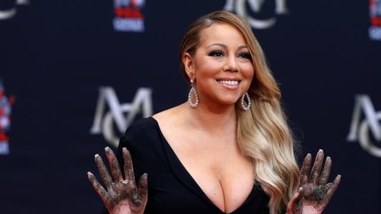Singer Mariah Carey shows her hands after placing them in cement in the forecourt of the TCL Chinese theatre in Los Angeles. (REUTERS)