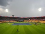 Groundsmen cover the pitch ahead of the ICC Men's Cricket World Cup 2023 match between New Zealand and Pakistan, at M. Chinnaswamy Stadium Groundsmen cover the pitch ahead of the ICC Men's Cricket World Cup 2023 match between New Zealand and Pakistan, at M. Chinnaswamy Stadium