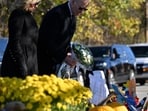 US President Joe Biden and First Lady Jill Biden pays their respects outside Schemengees Bar and Grille in Lewiston, Maine, on November 3, 2023 following a mass shooting on October 25. (AFP)