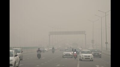 A road shrouded in smog in New Delhi on Friday. (PTI) A road shrouded in smog in New Delhi on Friday. (PTI)