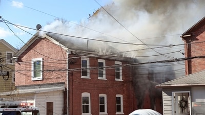 Firefighters work to extinguish fires inside the homes on Brick Row, in the Village of Wappingers Falls, NY, after a gas main was ruptured. (AP)