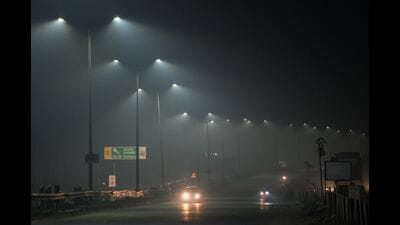 Cars ride along a highway engulfed by smog in Jalandhar. (AFP)